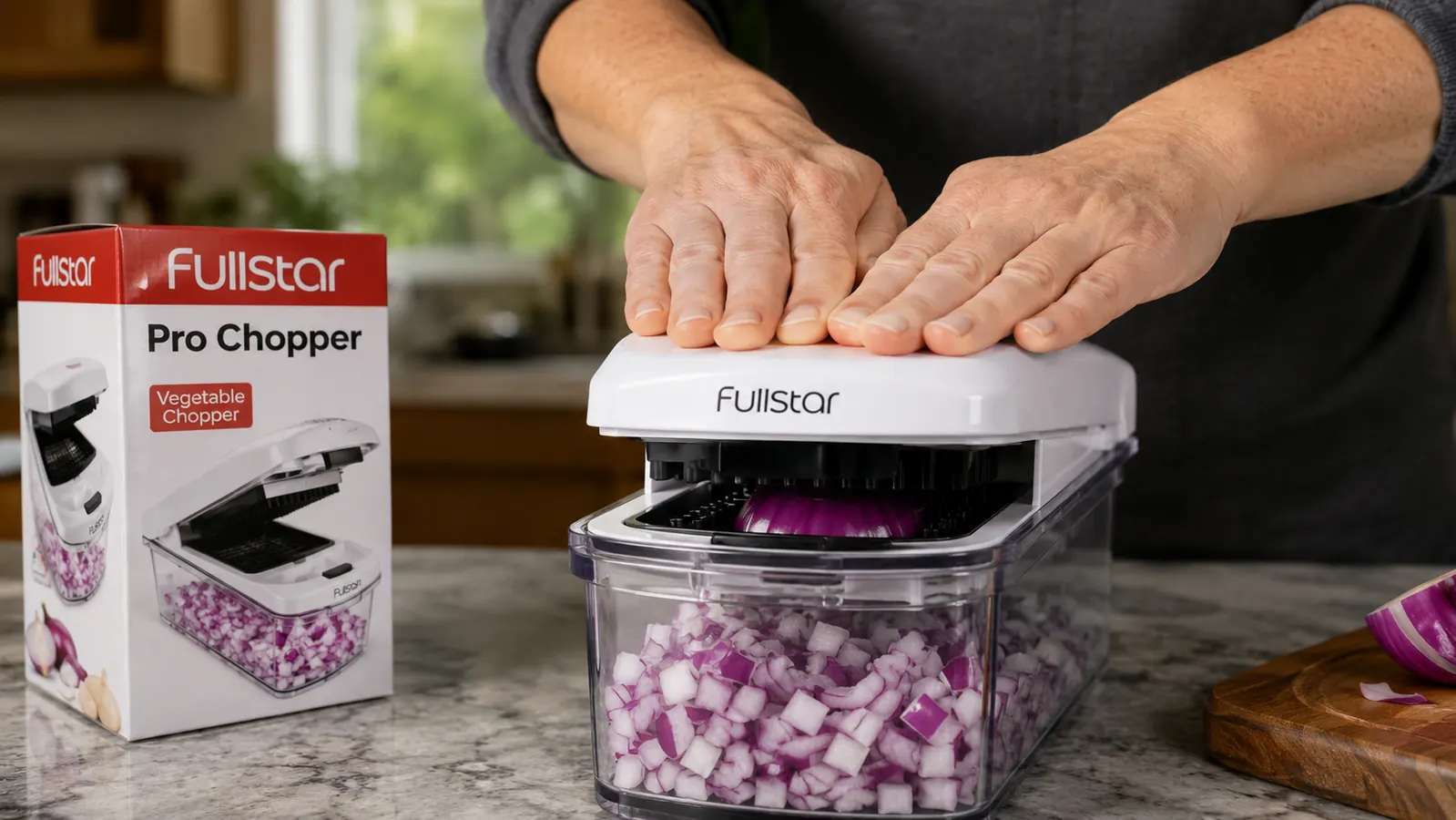 Hands pressing down on the Fullstar chopper lid to dice an onion into a clear collection container