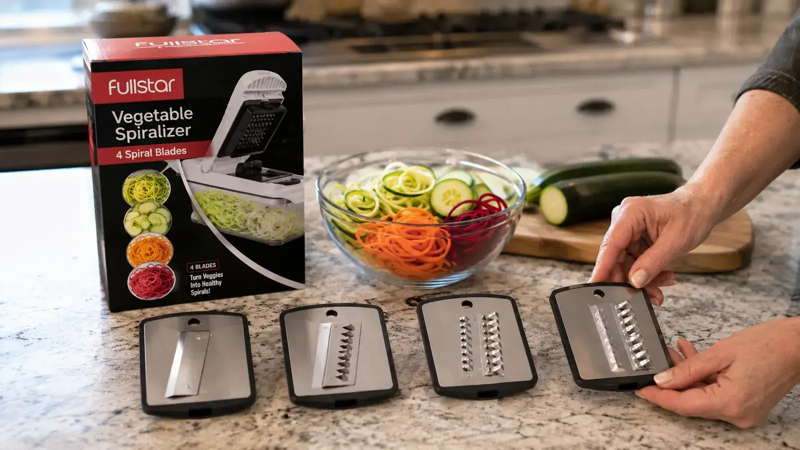 Close-up of the four Fullstar spiralizer blade attachments laid out on a kitchen counter